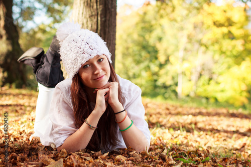Photo: Beautiful Teenager Girl in park during autumn. Caucasian Beauty. Beautiful Teenager Girl in park during autumn. Caucasian Beauty.