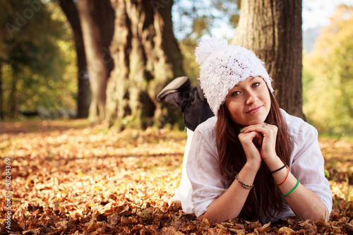 Photo: Beautiful Teenager Girl in park during autumn. Caucasian Beauty. Beautiful Teenager Girl in park during autumn. Caucasian Beauty.