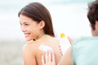Suntan lotion /  Sunscreen - young couple on beach