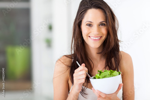 Photo: attractive young woman eating healthy salad attractive young woman eating healthy salad