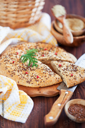 Photo: Oat bran and flax seed flatbread, selective focus Oat bran and flax seed flatbread, selective focus