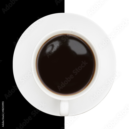 Photo: Highly stylised image of coffee cup and saucer on black and whit Highly stylised image of coffee cup and saucer on black and whit