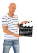 Photo: Attraktiver Mann hält Filmklappe Attraktiver Mann hält Filmklappe