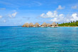 Photo: row of water bungalows on maldives with view over ocean row of water bungalows on maldives with view over ocean