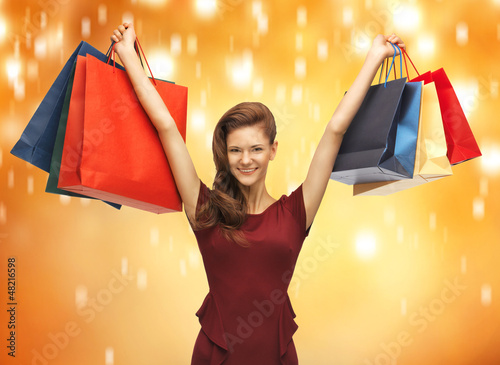 Photo: teenage girl in red dress with shopping bags teenage girl in red dress with shopping bags