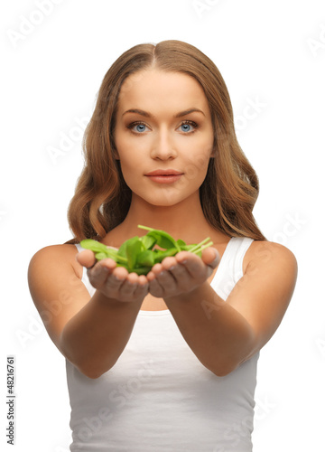 Photo: woman with spinach leaves on palms woman with spinach leaves on palms