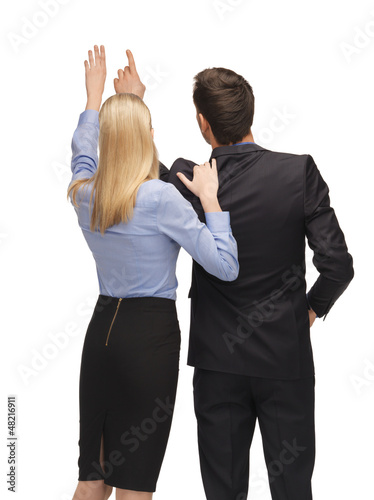 Photo: man and woman working with something imaginary man and woman working with something imaginary