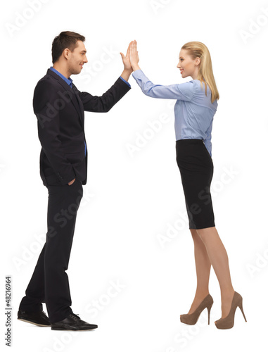 Photo: man and woman giving a high five man and woman giving a high five