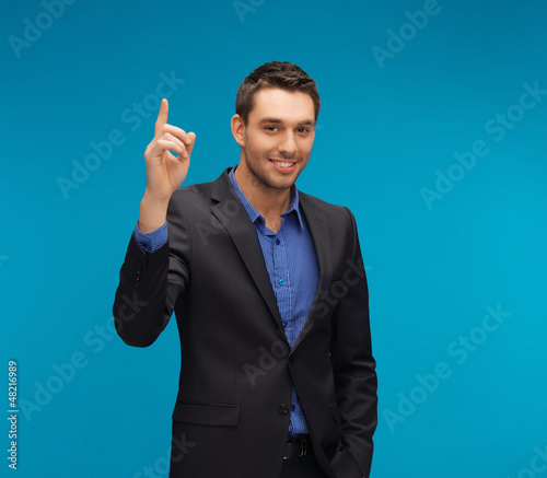 Photo: man in suit with his finger up man in suit with his finger up