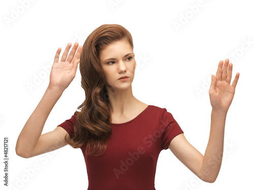 Photo: teenage girl working with something imaginary teenage girl working with something imaginary