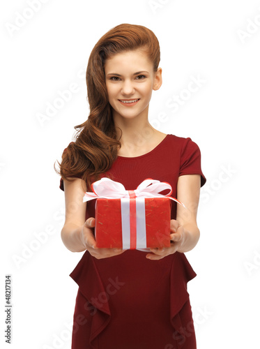 Photo: teenage girl in red dress with gift box teenage girl in red dress with gift box