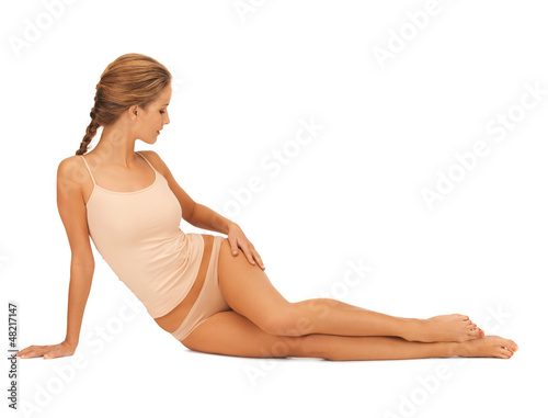 Photo: woman in cotton underwear touching her legs woman in cotton underwear touching her legs