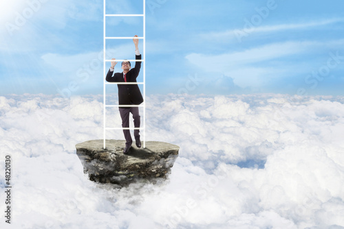 Photo: Businessman climbs stairs above clouds Businessman climbs stairs above clouds