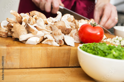 Photo: Midsection Of Man Cutting Mushrooms Midsection Of Man Cutting Mushrooms