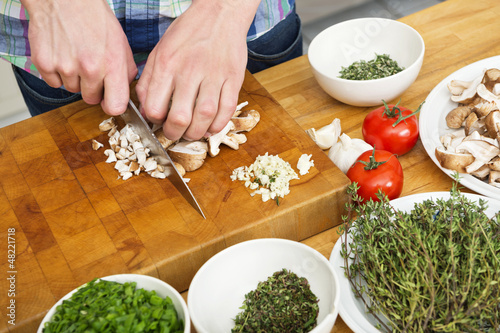 Photo: Closeup Of Man Chopping Mushrooms Closeup Of Man Chopping Mushrooms