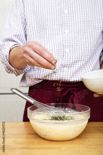 Photo: Man Sprinkling Thymes In Batter Man Sprinkling Thymes In Batter