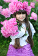 portrait of little girl outdoors with peony