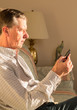Senior man reading eBook on couch