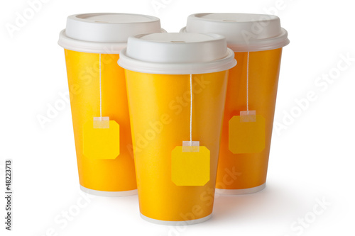 Illustration: Three take-out teacups with teabags Three take-out teacups with teabags