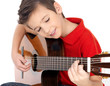 Smiling boy is playing the acoustic guitar