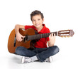 happy  boy is playing on acoustic guitar