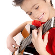 Smiling boy is playing on acoustic guitar