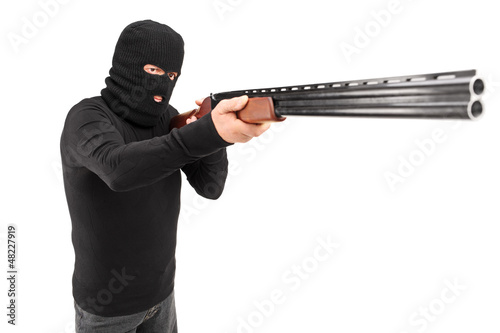Photo: A man with robbery mask attacking someone with shotgun A man with robbery mask attacking someone with shotgun