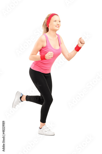 Photo: Full length portrait of a young female running Full length portrait of a young female running