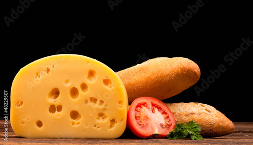 Photo: block of cheese and bread isolated on black block of cheese and bread isolated on black
