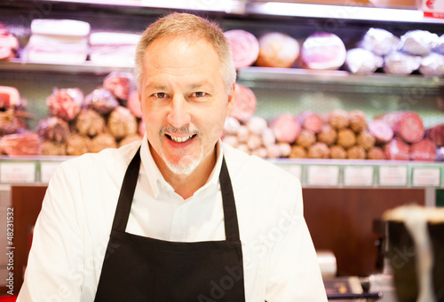 Photo: Smiling shopkeeper Smiling shopkeeper