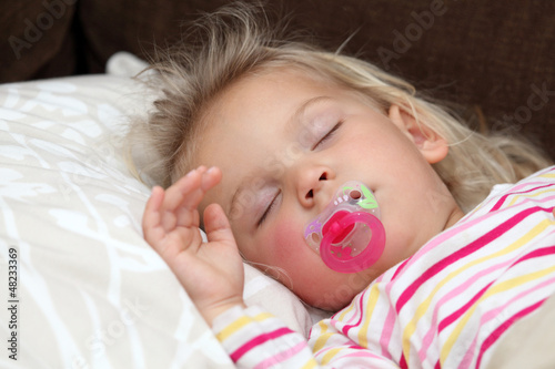 Photo: Toddler girl sleeping in bed Toddler girl sleeping in bed