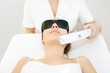 Photo: Young woman receiving laser therapy Young woman receiving laser therapy