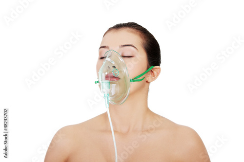 Photo: Diseased female patient wearing a oxygen mask Diseased female patient wearing a oxygen mask