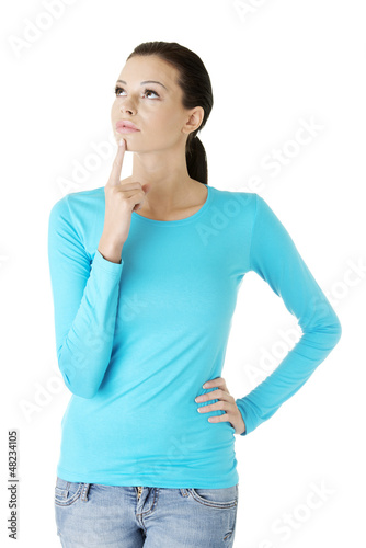Photo: Thoughtful female student looking up Thoughtful female student looking up