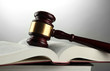 wooden gavel and books, on grey background