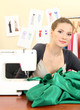 beautiful young dressmaker in workroom