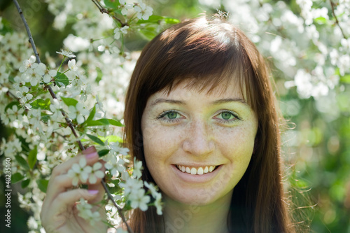 Photo: girl in spring blossoming garden girl in spring blossoming garden