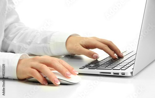 Photo: female hands writing on laptot, close up female hands writing on laptot, close up