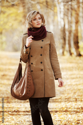 Photo: Young woman walking in autumn forest Young woman walking in autumn forest