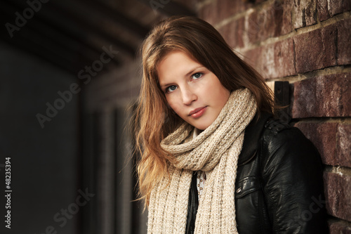 Photo: Teenage girl against a brick wall Teenage girl against a brick wall
