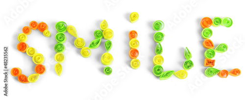 Photo: The word smile is made of quilling isolated on white The word smile is made of quilling isolated on white