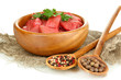 Raw beef meat in bowl with herbs and spices isolated on white