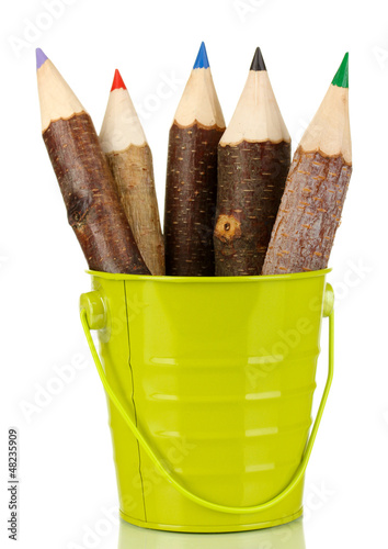 Photo: Colorful wooden pencils in green pail isolated on white Colorful wooden pencils in green pail isolated on white
