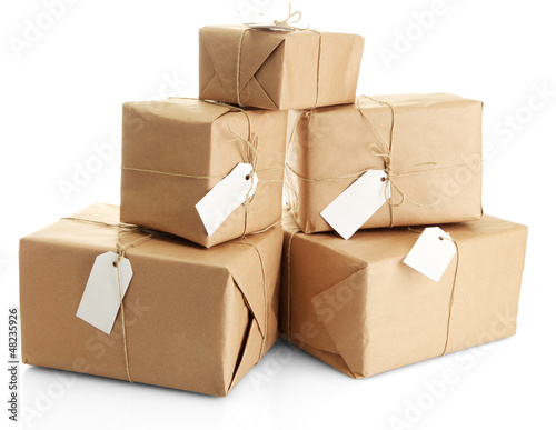 Photo: parcels boxes with kraft paper, isolated on white parcels boxes with kraft paper, isolated on white