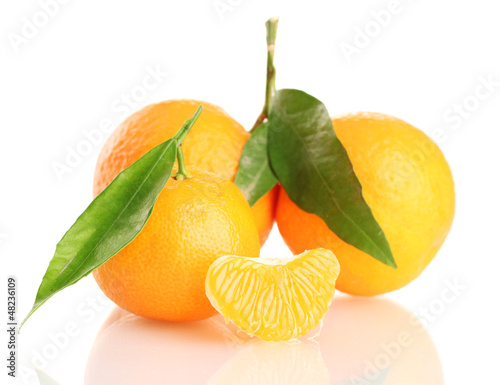 Photo: Ripe sweet tangerine with leaves, isolated on white Ripe sweet tangerine with leaves, isolated on white