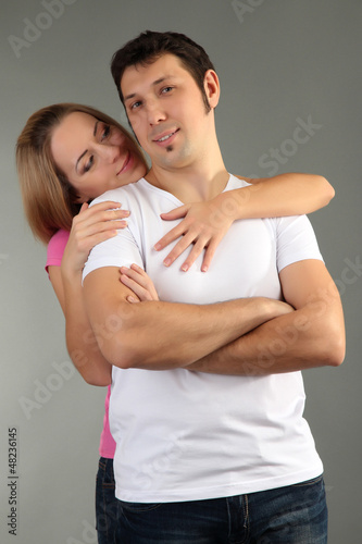Photo: Loving couple on grey background Loving couple on grey background