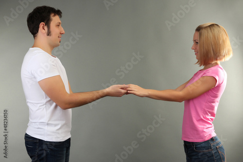 Photo: Loving couple on grey background Loving couple on grey background