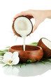 Coconut with coconut milk and leaves, isolated on white