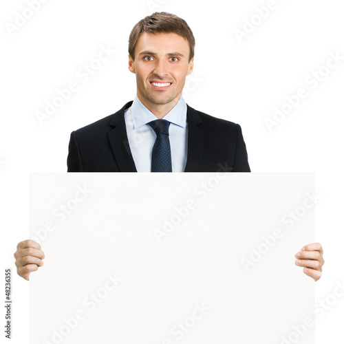 Photo: Happy businessman showing signboard, isolated Happy businessman showing signboard, isolated