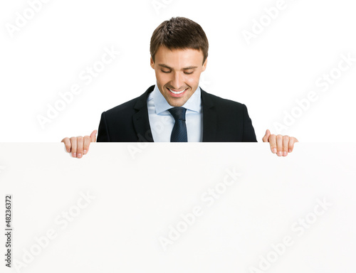 Photo: Happy businessman showing signboard, isolated Happy businessman showing signboard, isolated